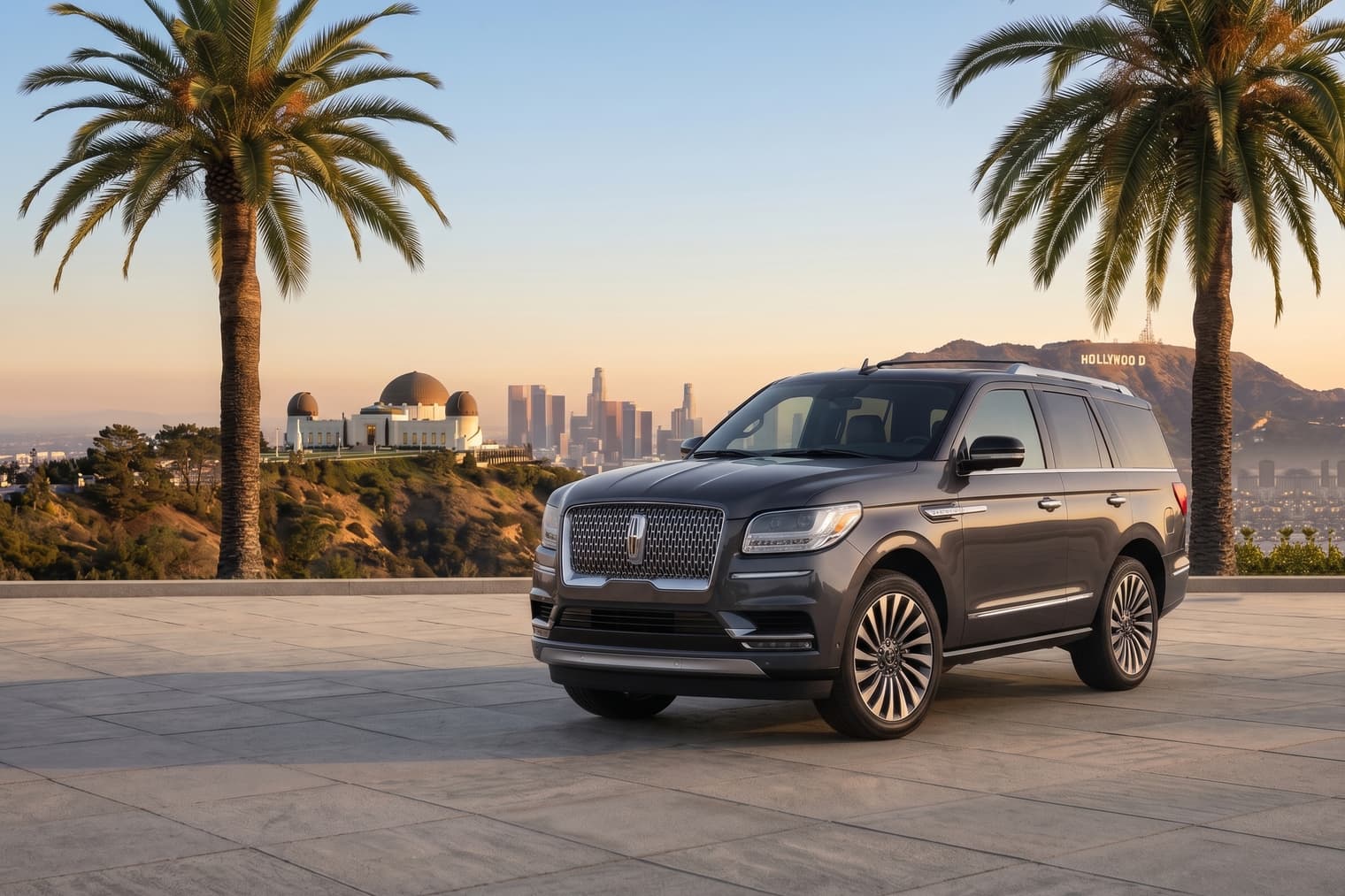 Our private Lincoln Navigator SUV at a Griffith Observatory overlook — Downtown LA and the Hollywood Sign behind